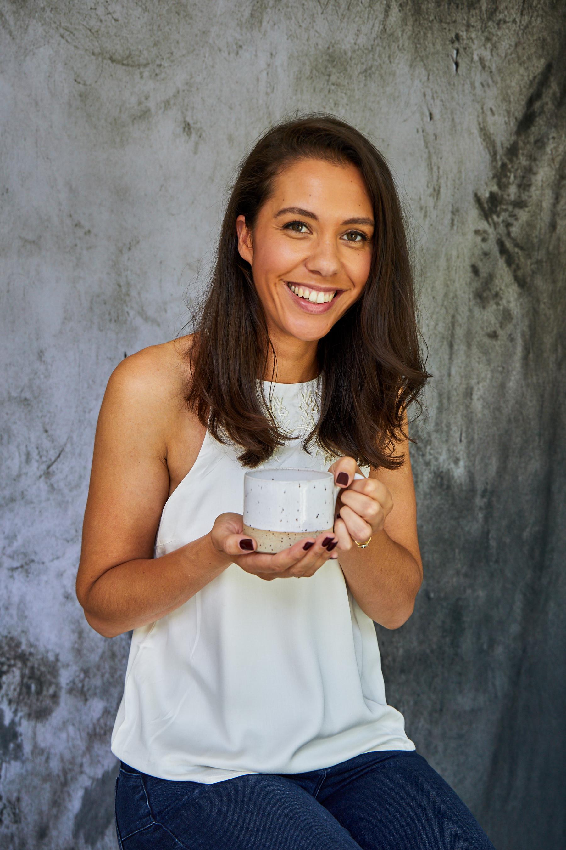 Jade Boswell holding a handmade ceramic mug