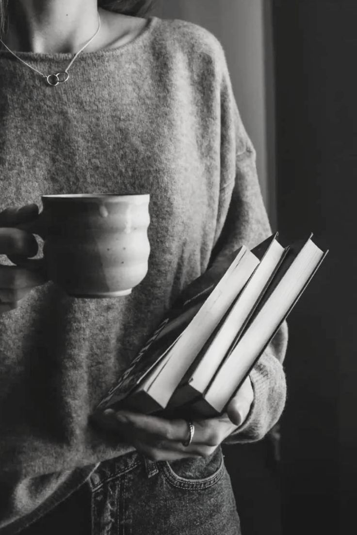Editorial still life — grey knit, mug and stack of books