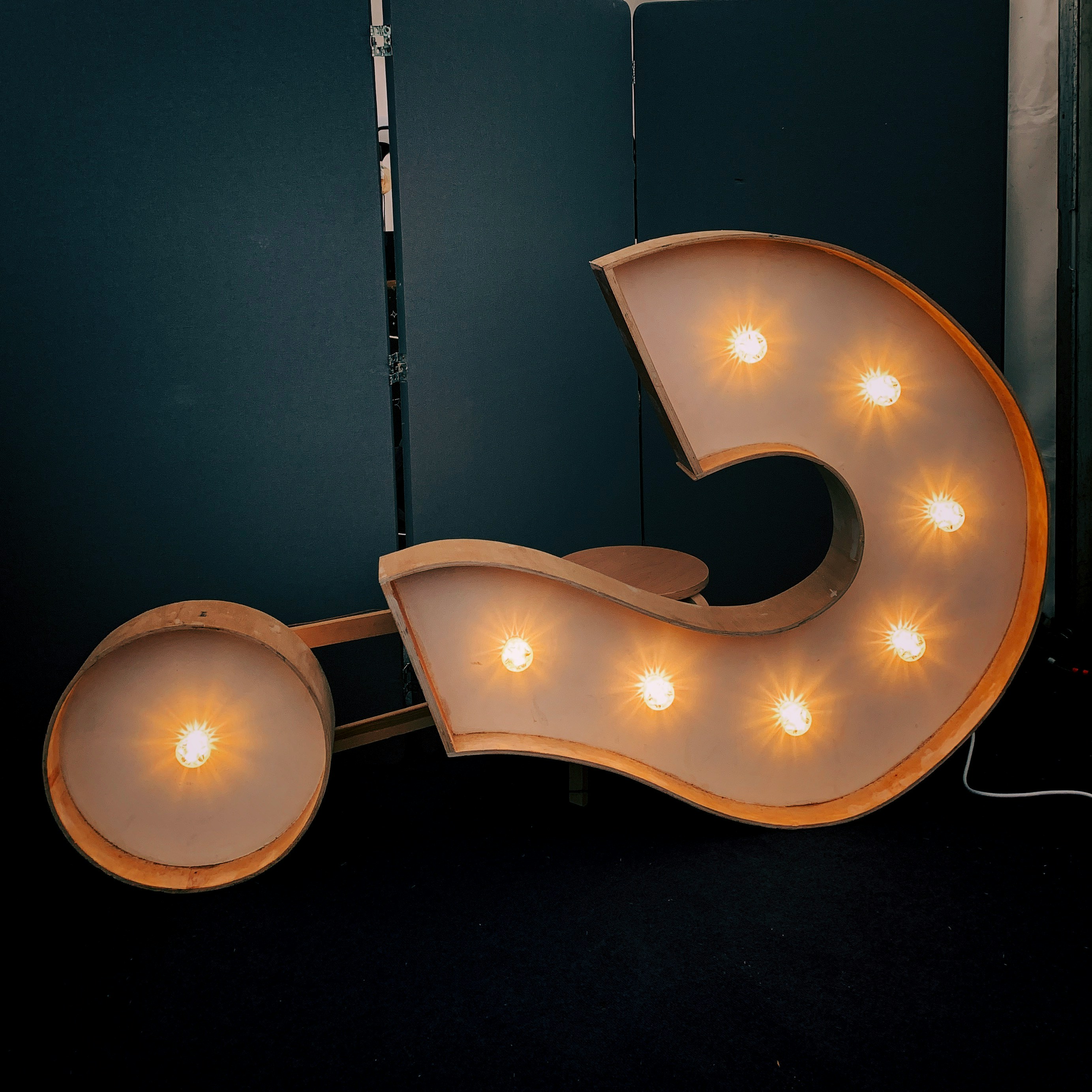 Illuminated marquee question mark sign