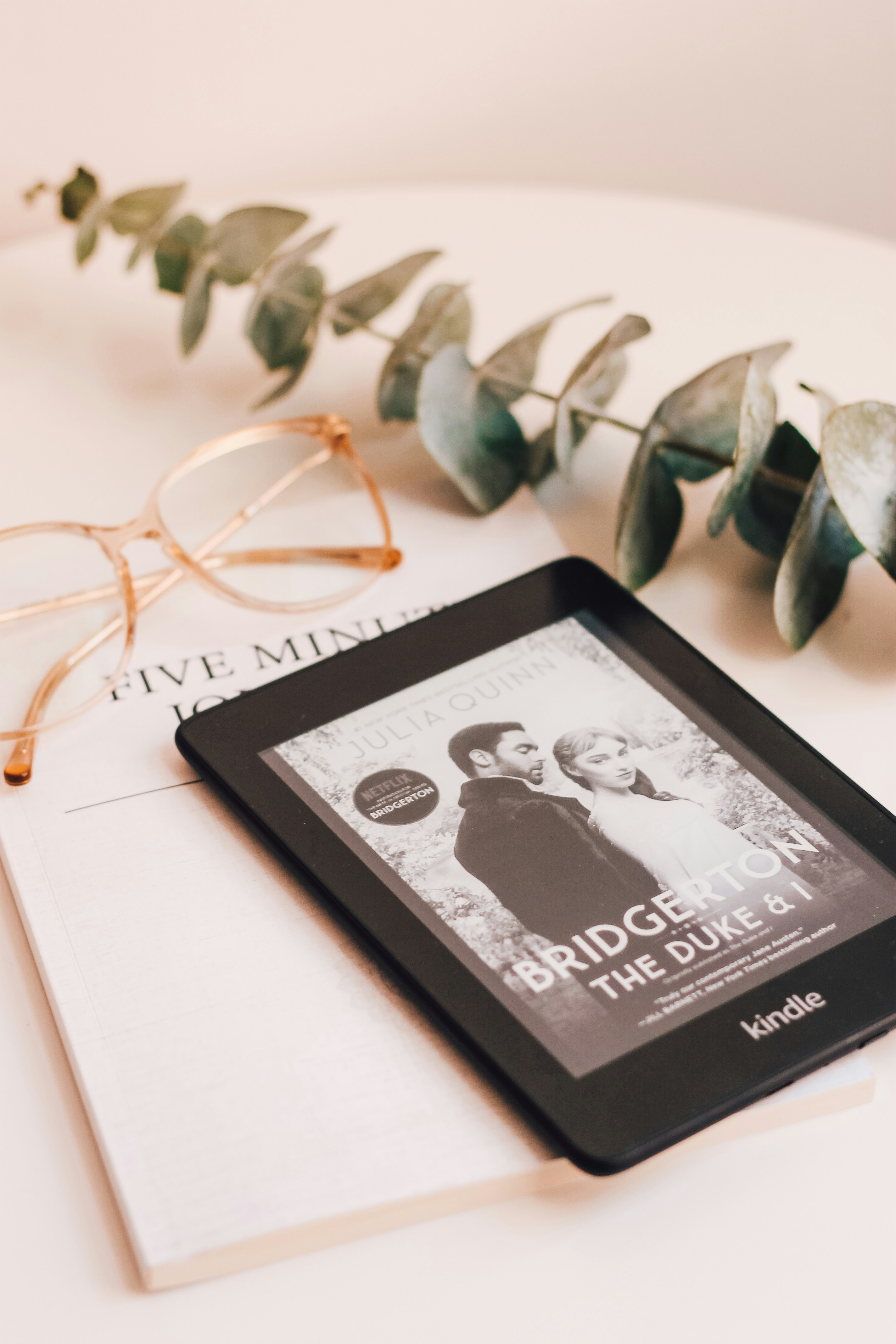 Kindle, Bridgerton novel, eucalyptus and glasses flatlay