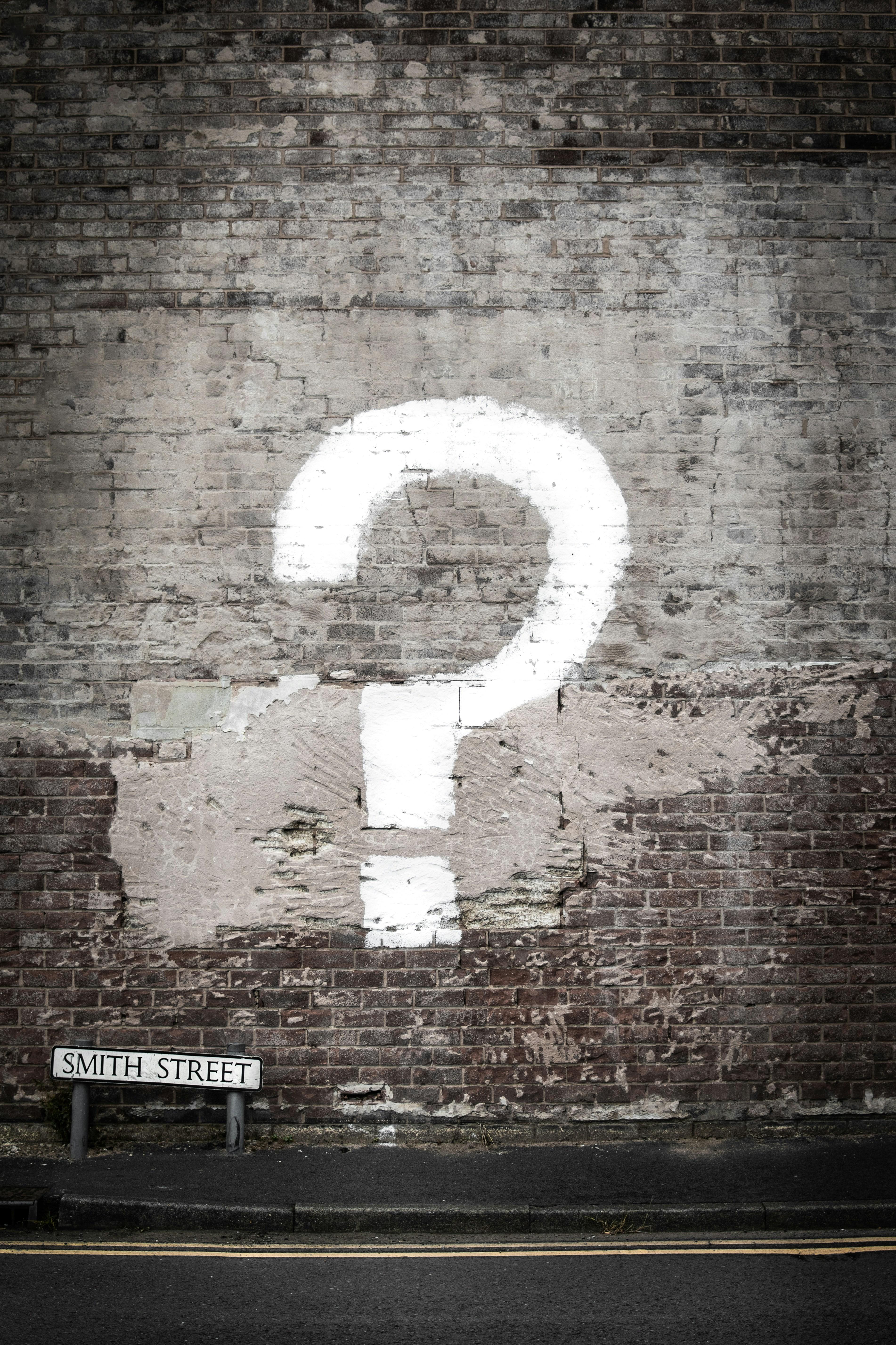 Painted question mark on a brick wall on Smith Street